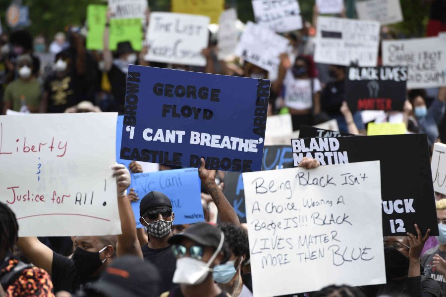 Demonstrators protest in Centennial Olympic Park, Friday, May 29, 2020 in Atlanta. Protests were organized in cities around the United States following the death of George Floyd during an arrest in Minneapolis. (AP Photo/Mike Stewart)