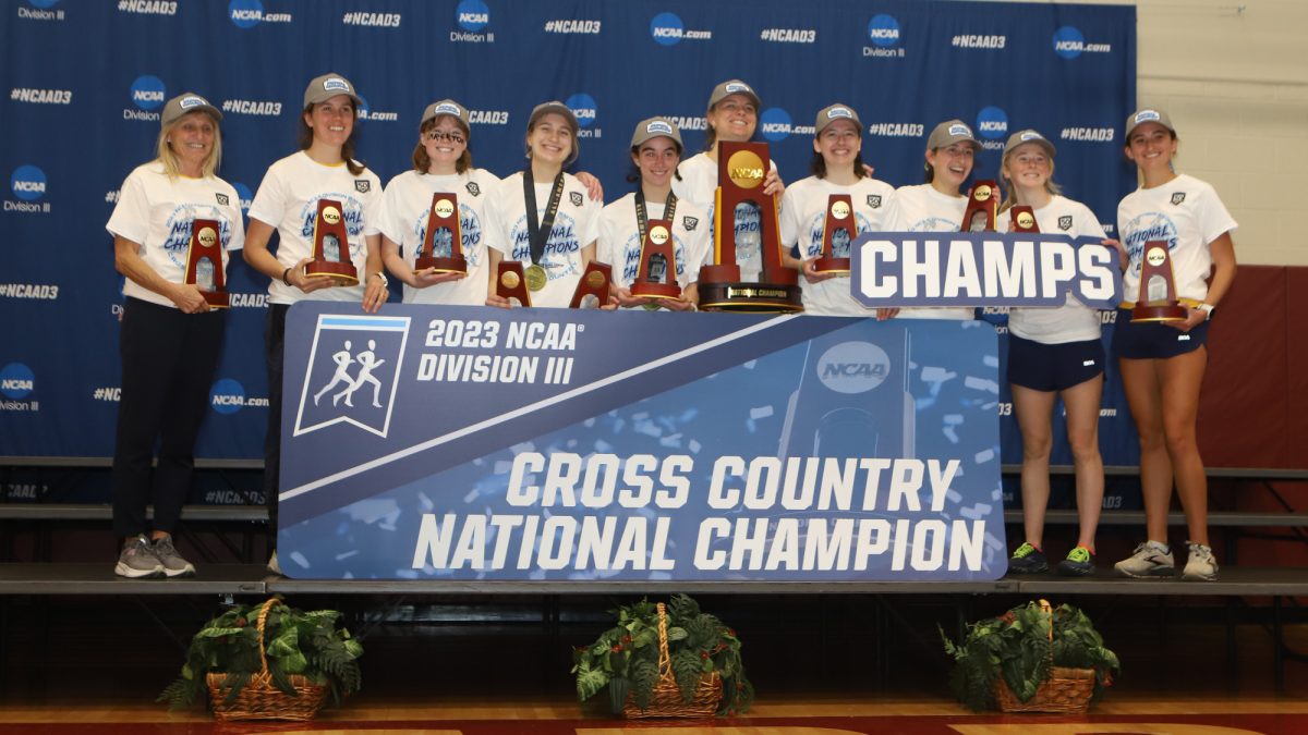 Nora Daley ’27, Hannah Preisser ’26, Phoebe Ward ’24, Helen Cross ’24, Mary Blanchard ’24, Libby Rowland ’25, Sophie McManus ’25 and Aliya Larsen ’26 receive their trophies after winning the DIII Cross Country National Championship on Nov. 18, 2023.